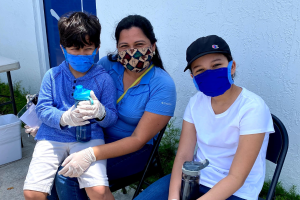 Mother and sons wearing masks