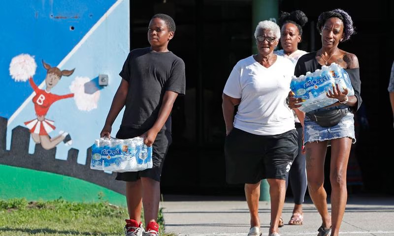 People carrying bottled water